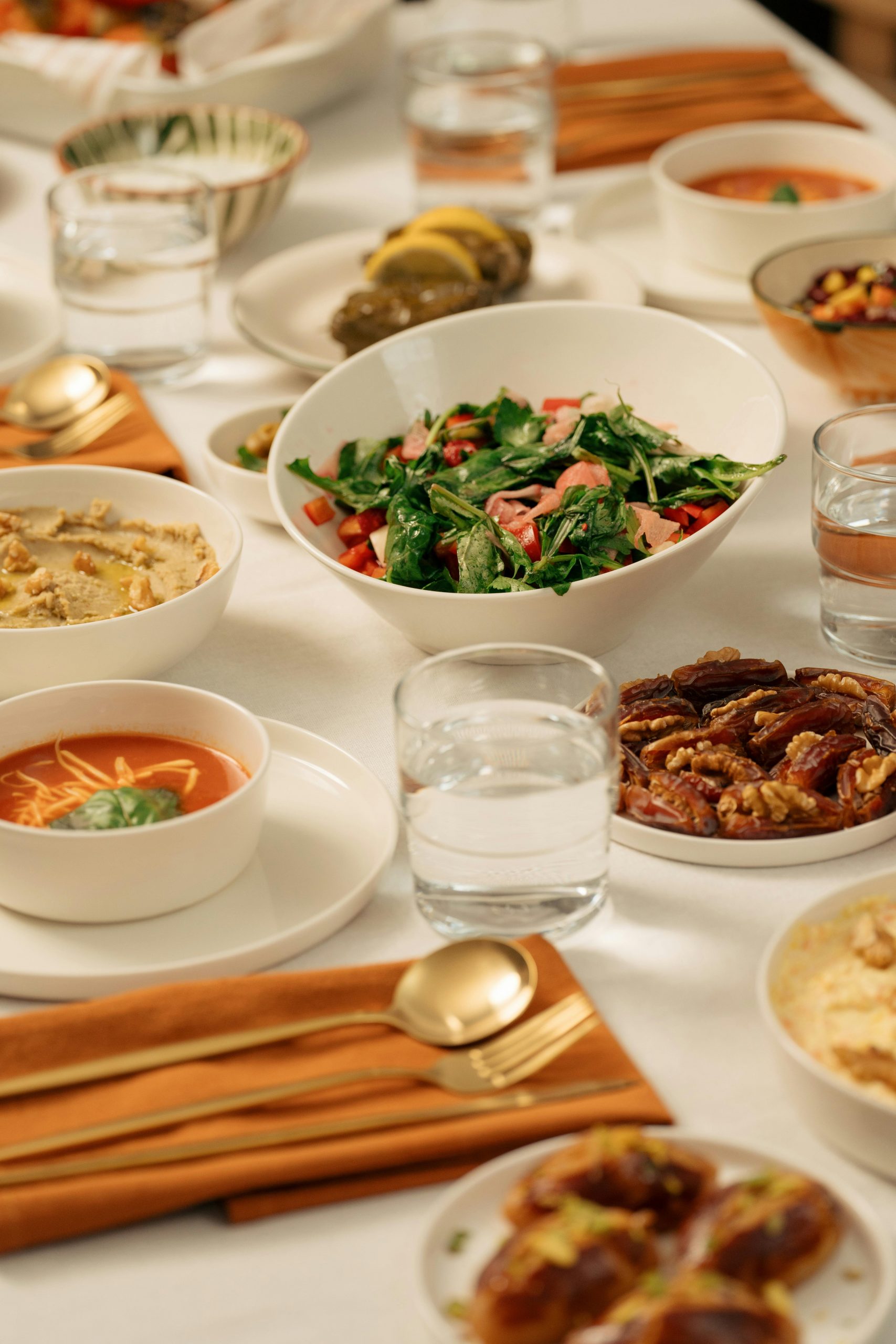 An inviting iftar table setting with various Middle Eastern dishes and cutlery.