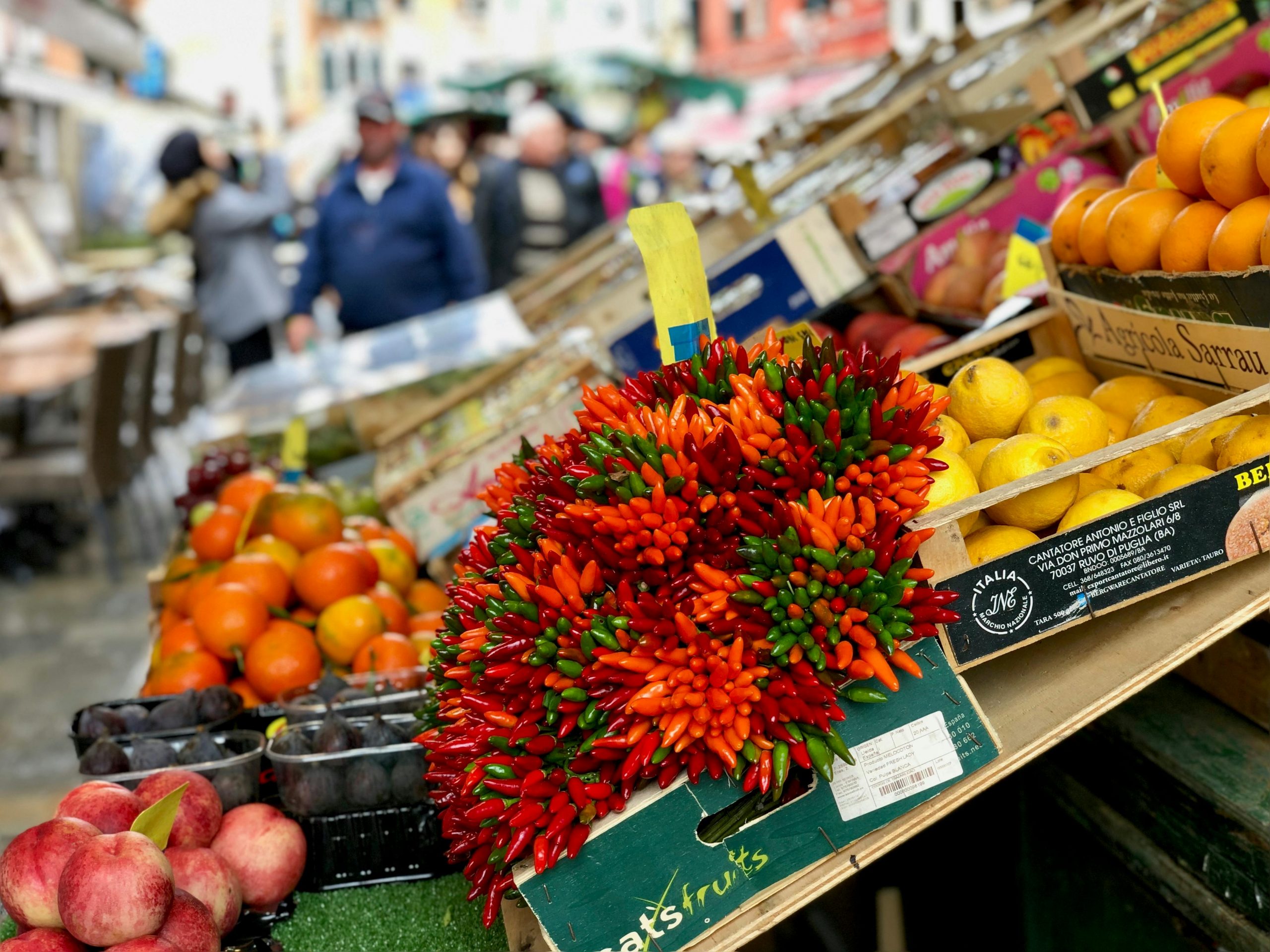 Vibrant produce display at a bustling market in Venice, Italy.